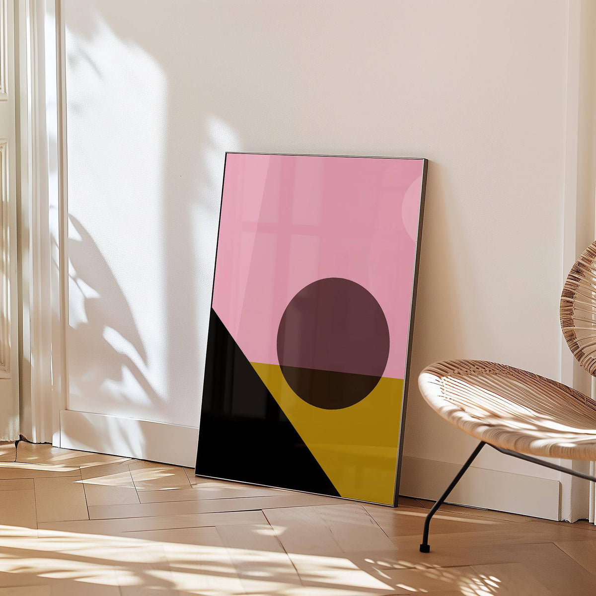 Bright Colored Artwork print leaning on a wall with shadows and a rattan chair nearby