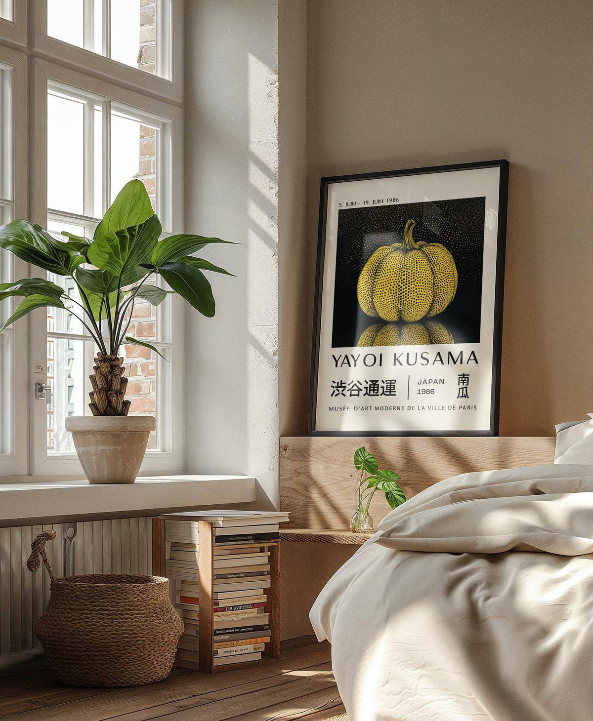 Print leaning on a bed headboard with a yellow polka dot pumpkin artwork and a plant on the windowsill