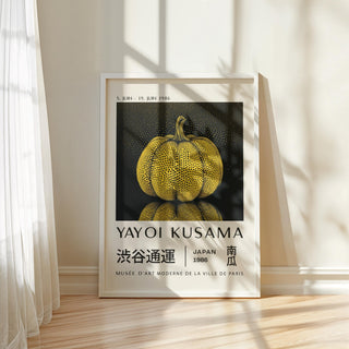 Framed print of a yellow polka dot pumpkin with text beneath leaning against a wall with shadows