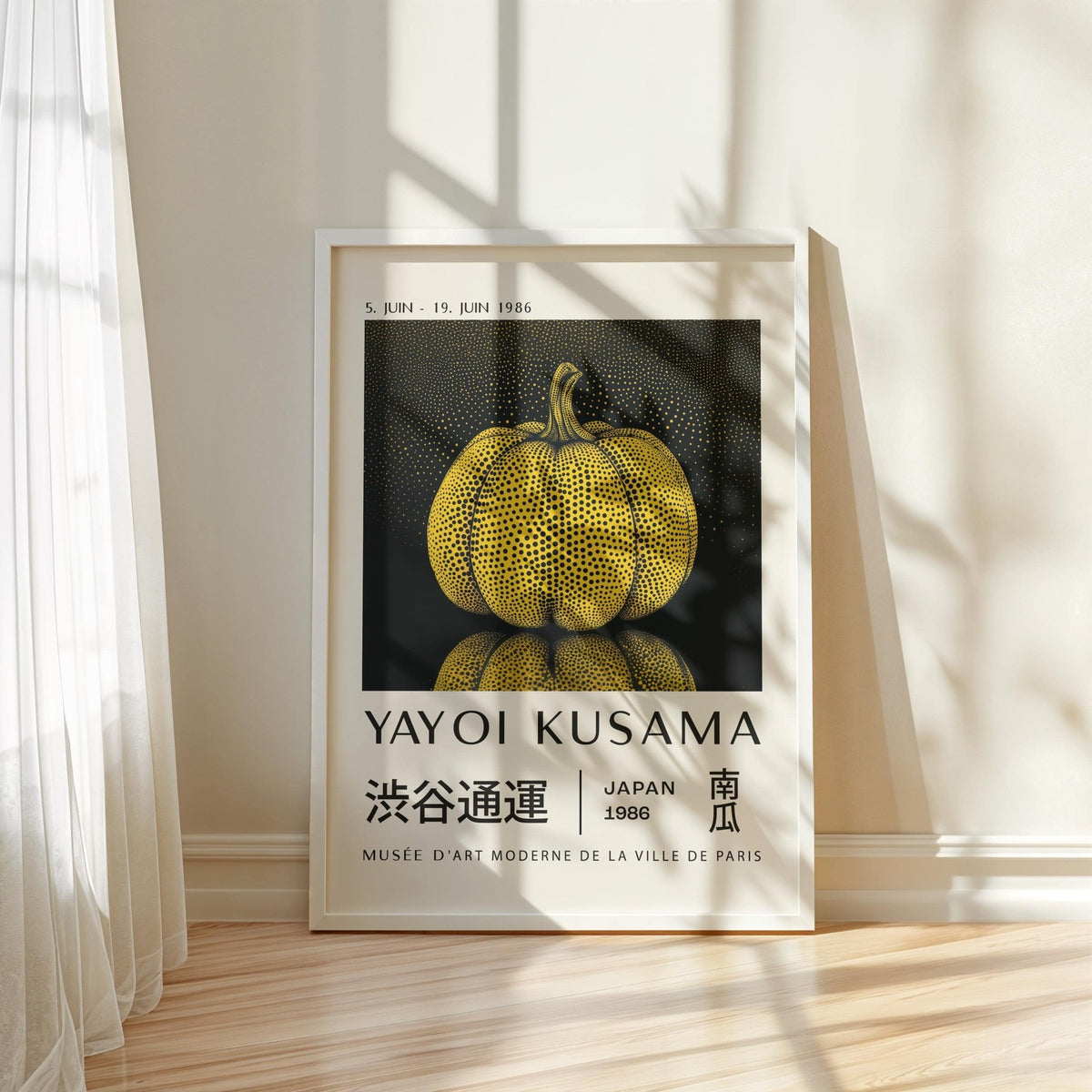 Framed print of a yellow polka dot pumpkin with text beneath leaning against a wall with shadows