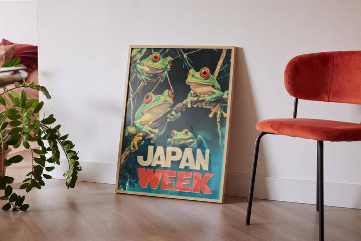 Print leaning on a floor with Japanese Frog Prints of red-eyed frogs on branches next to a red chair