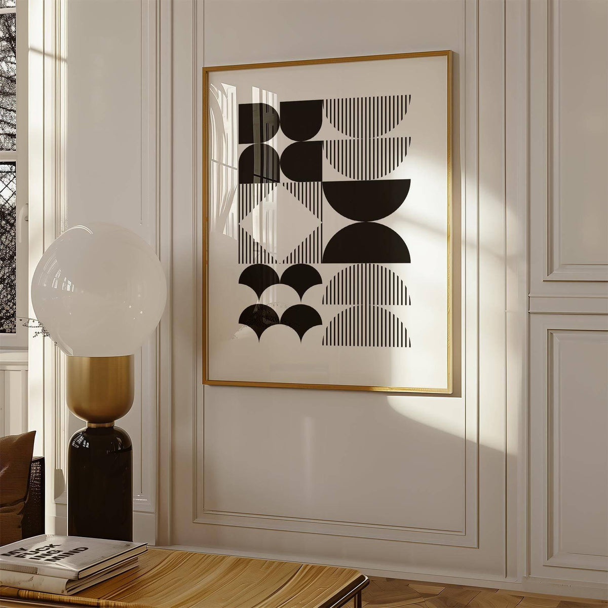 Black and White Geometric Wall Art with black shapes and lines in a sunlit room beside a lamp