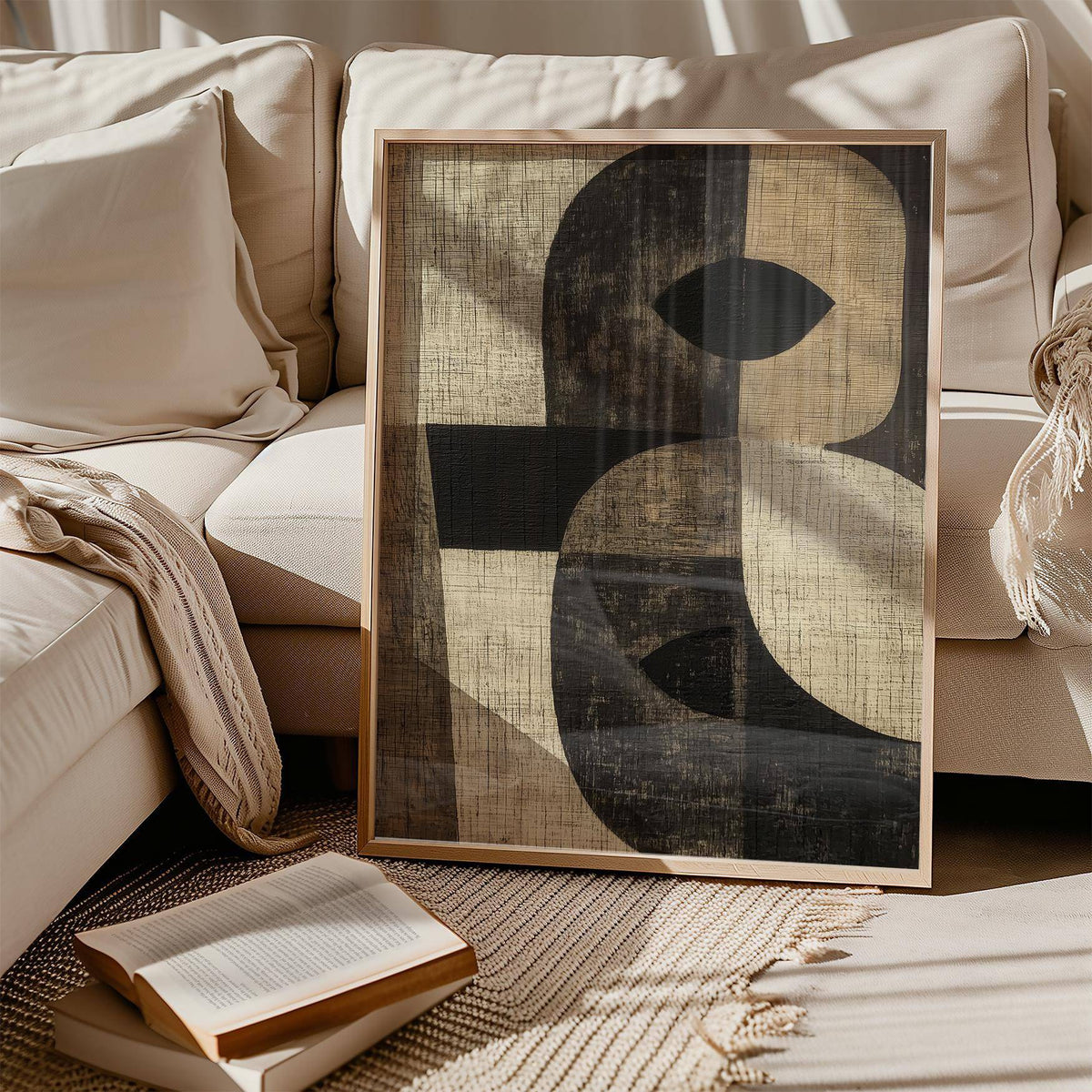 Large Owl Wall Art framed print leaning on a beige sofa with a throw and open book nearby