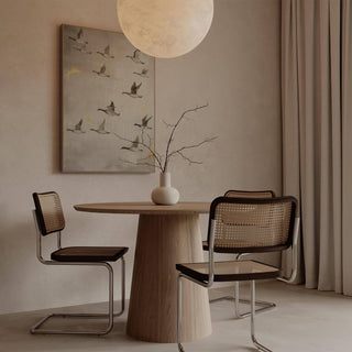 Dining room print showing flying geese in muted greys and beige beside a wooden table with a vase