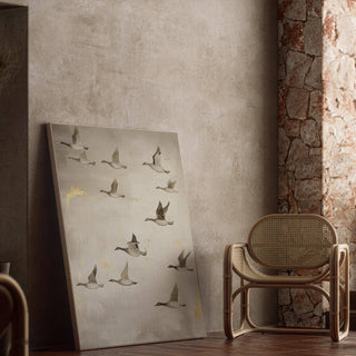 Oriental artwork leaning against a textured wall with flying geese in muted tones next to a cane chair