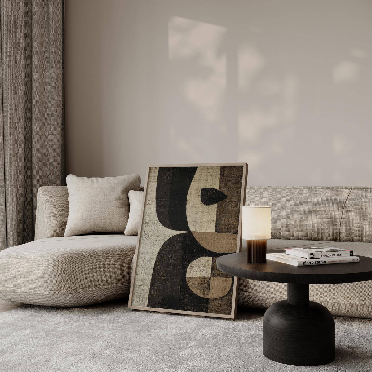 Earthy Tones Wall Art leaning on a sofa with abstract shapes in brown and beige tones next to a black side table with a lamp