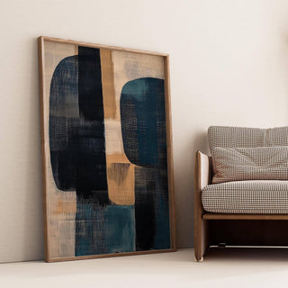 Wabi Sabi Painting leaning with abstract shapes in black and blue beside a patterned sofa