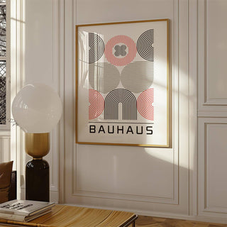 Wall Art for Home Office with abstract geometric shapes in black red and beige above a table with books and a lamp