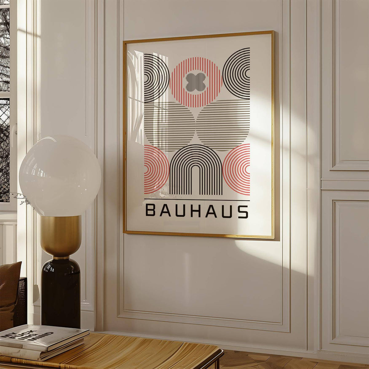Wall Art for Home Office with abstract geometric shapes in black red and beige above a table with books and a lamp