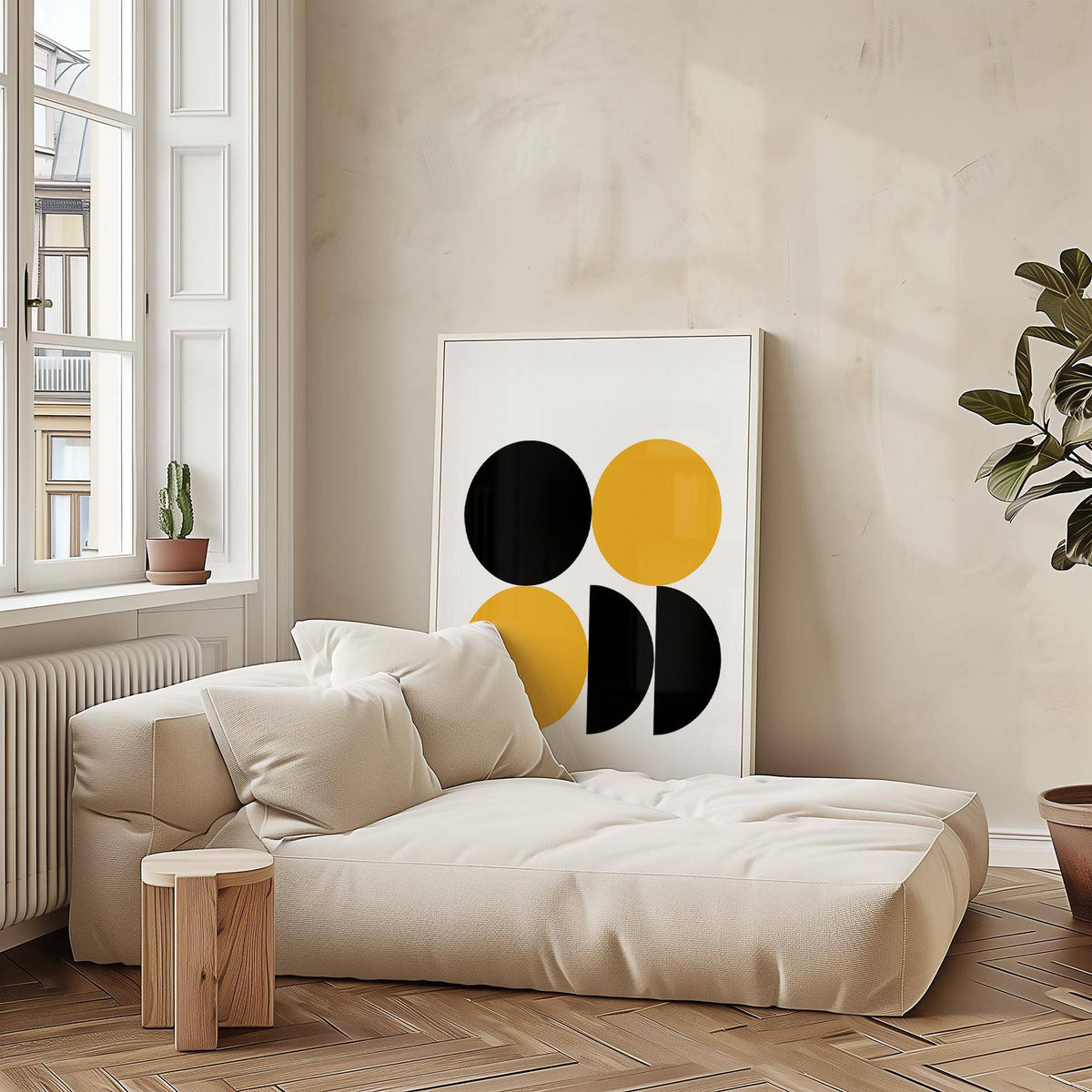 Geometric posters leaning on floor by beige lounge with natural light and potted plant