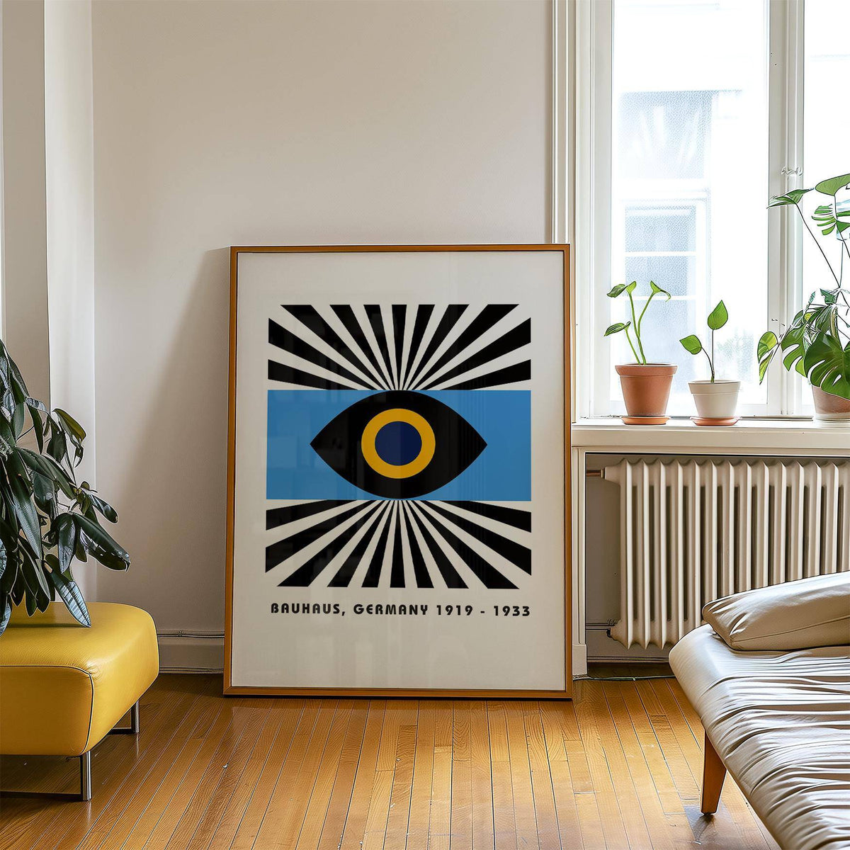 Modern Art Geometric print leaning on floor showing abstract eye graphic in black yellow and blue with plants on windowsill