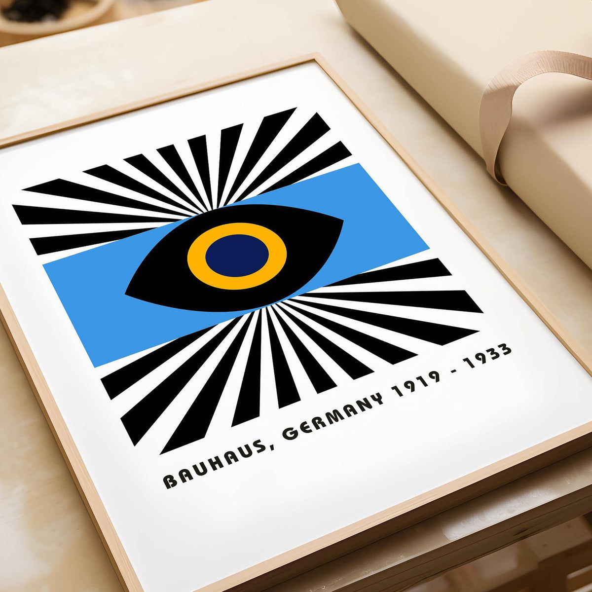 Modern Art Geometric framed print close-up of a colourful abstract eye graphic beside a rolled paper