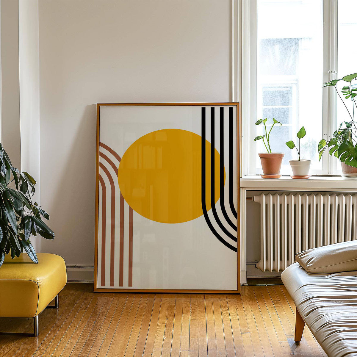 Print leaning on wooden floor of an orange sun circle with black and brown curved stripes next to plants