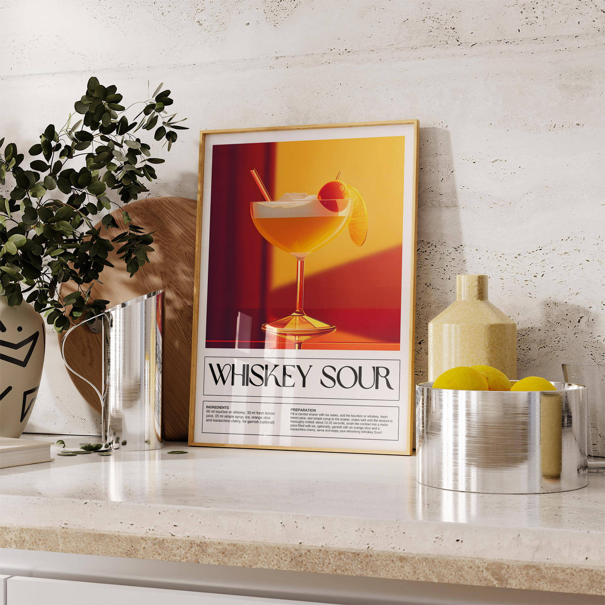 Print leaning on a shelf of a whiskey sour cocktail illustration with warm yellow and red colours next to a vase with leaves and lemon bowl