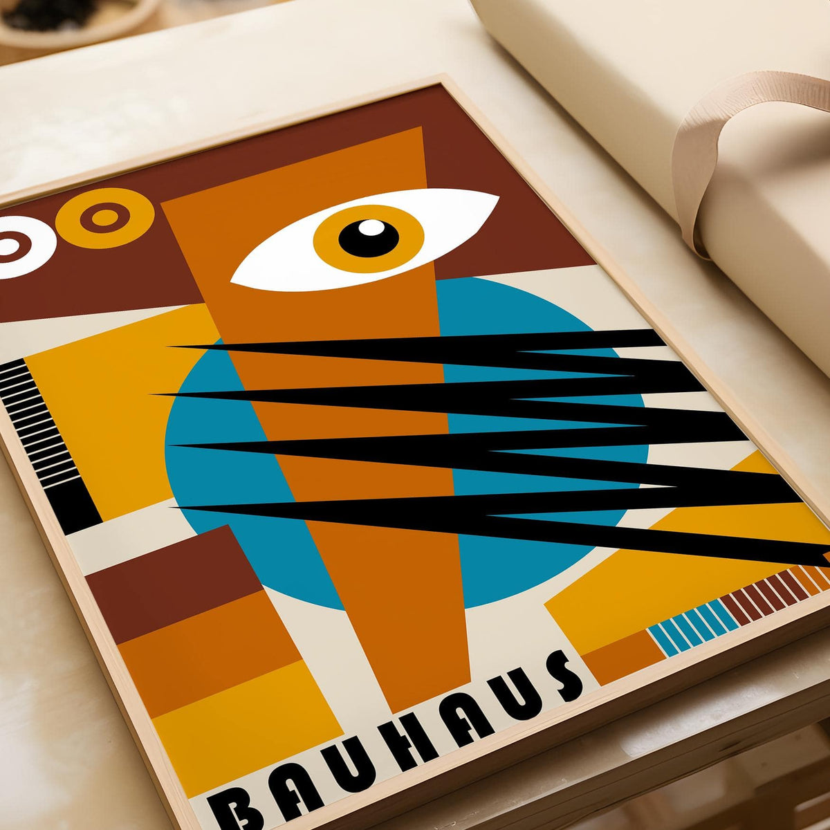 Close-up of the geometric poster showing abstract eye and Bauhaus style shapes in rich brown and blue
