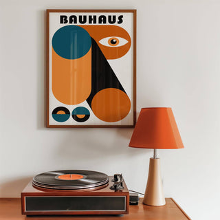 Fun Colorful Print framed print with orange and teal geometric shapes above a turntable and orange lamp