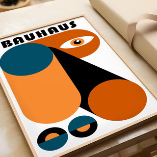 Framed close-up of Fun Colorful Print showing abstract geometric shapes in orange and blue with a tan gift box nearby