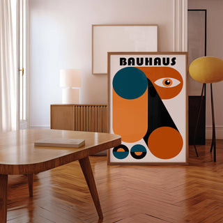 Fun Colorful Print leaning on floor with orange, teal and black geometric shapes near lamp