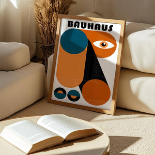 Fun Colorful Print leaning on a beige carpet between seating and dried plants with orange and blue shapes
