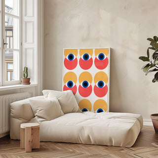 Wall Art Eye print with abstract eyes pattern in yellow, red and blue leaning on a beige sofa with cushions
