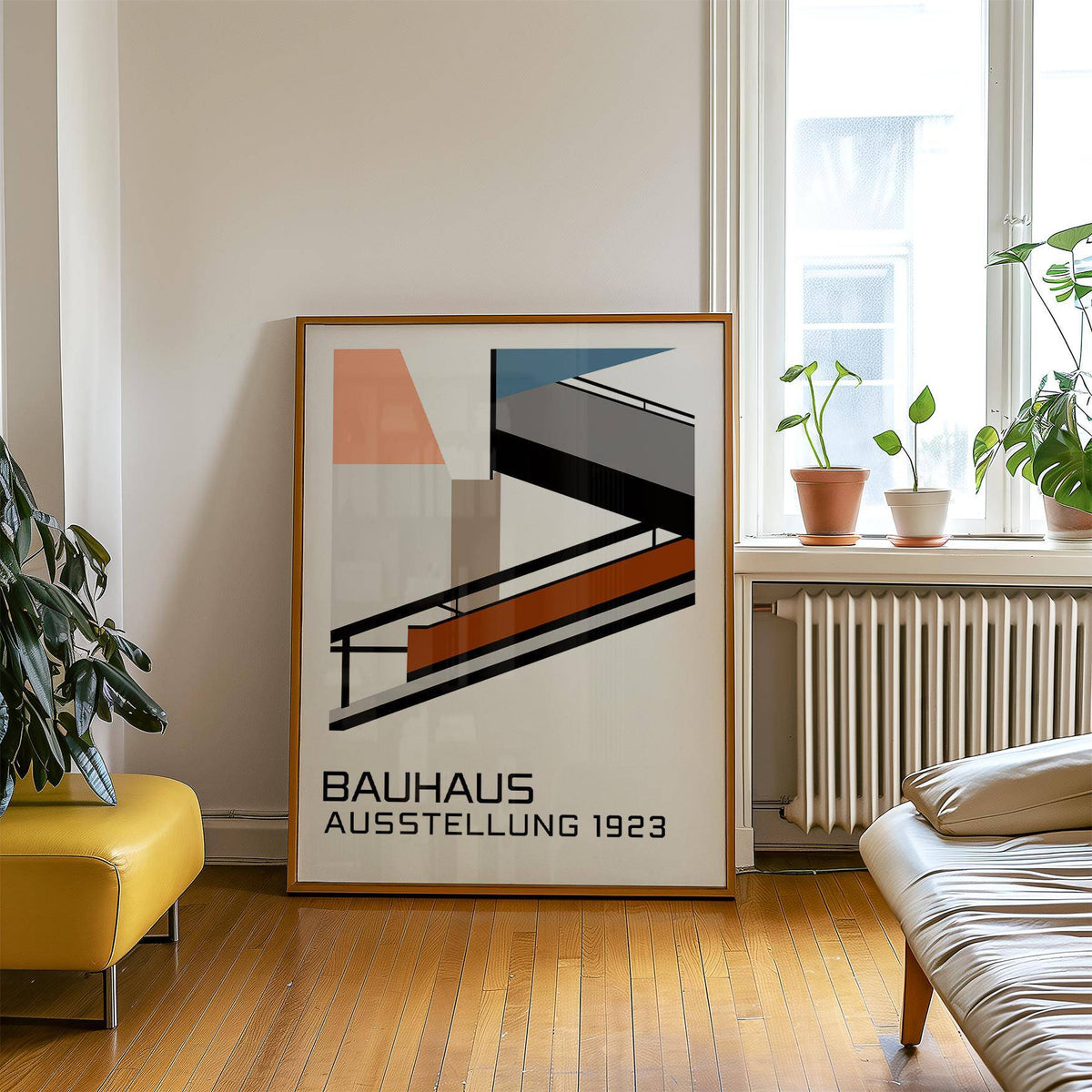 Print leaning on a wooden floor of Bauhaus Exhibition Poster 1923 with plants on a radiator nearby