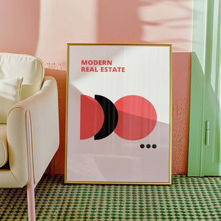 Red Black and White wall art leaning against a pink wall next to a cream sofa with cushion