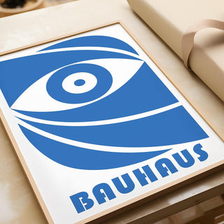 Close-up of a Bauhaus framed print showing a blue stylized eye with bold lines and geometric shapes