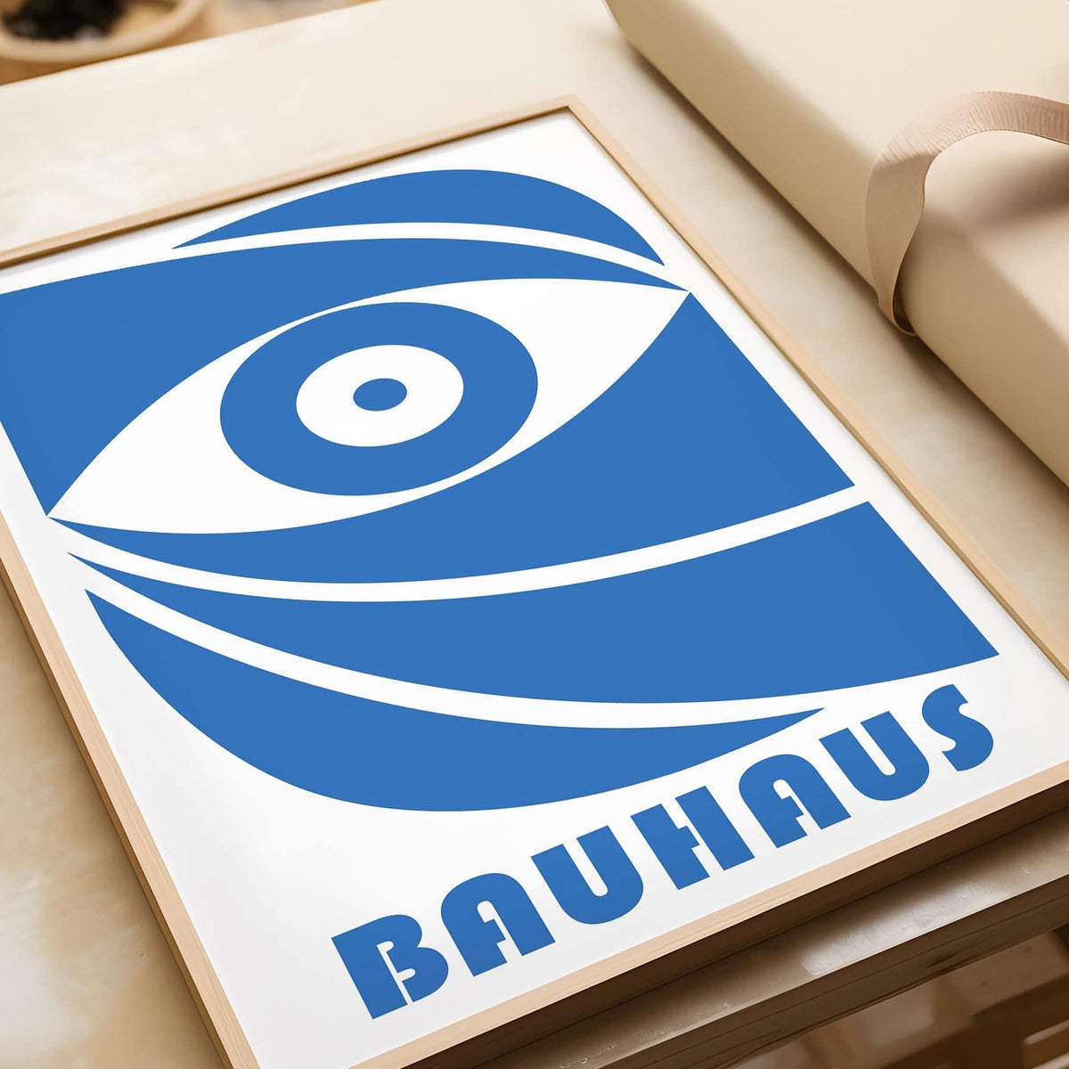 Close-up of a Bauhaus framed print showing a blue stylized eye with bold lines and geometric shapes