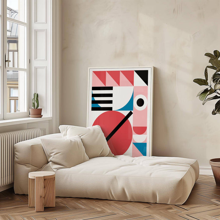 Colorful Geometric Art print leaning on wall with neutral sofa and plant nearby