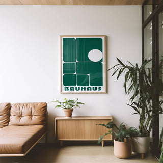 Art for Office framed print with green geometric shapes and Bauhaus text above a wooden sideboard with a plant