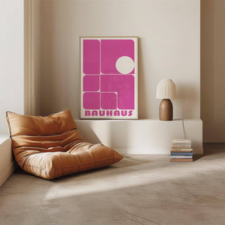 Wall Art Pink framed print with abstract geometric shapes in pink and white beside a lamp on a white ledge