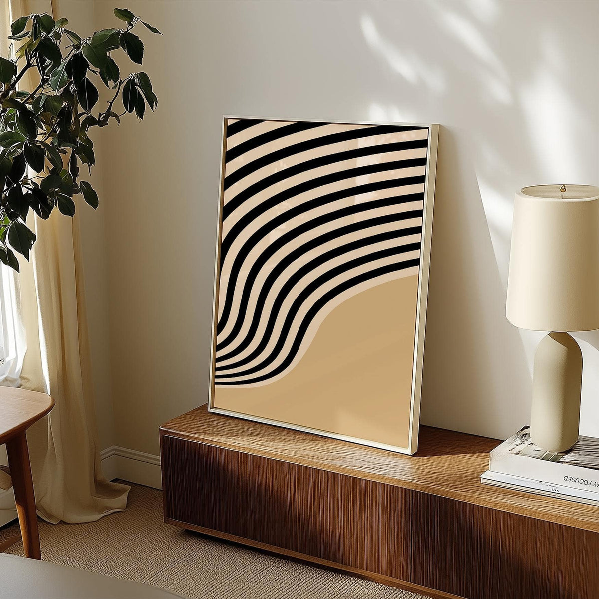 Print leaning on a sideboard of beige abstract art with curved black stripes and soft light