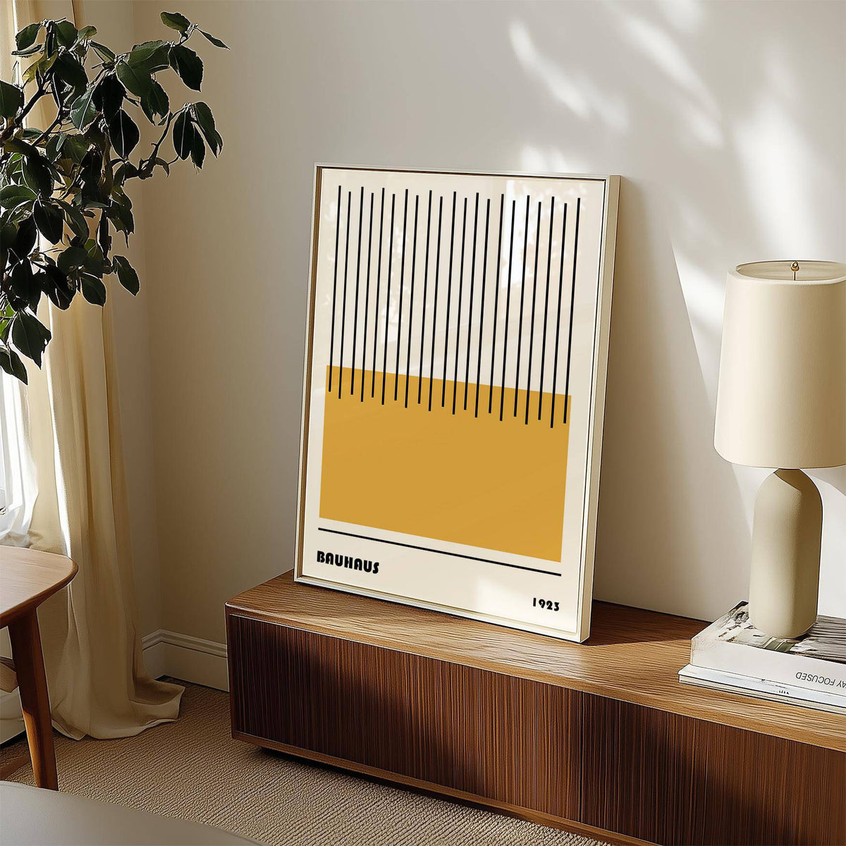 Framed modern geometric art with yellow rectangle and black lines leaning on a wooden cabinet