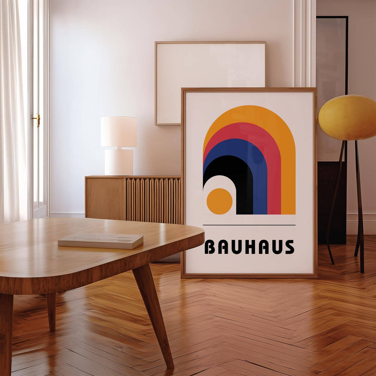 Bauhaus art poster print leaning on wooden floor with a table and lamp nearby