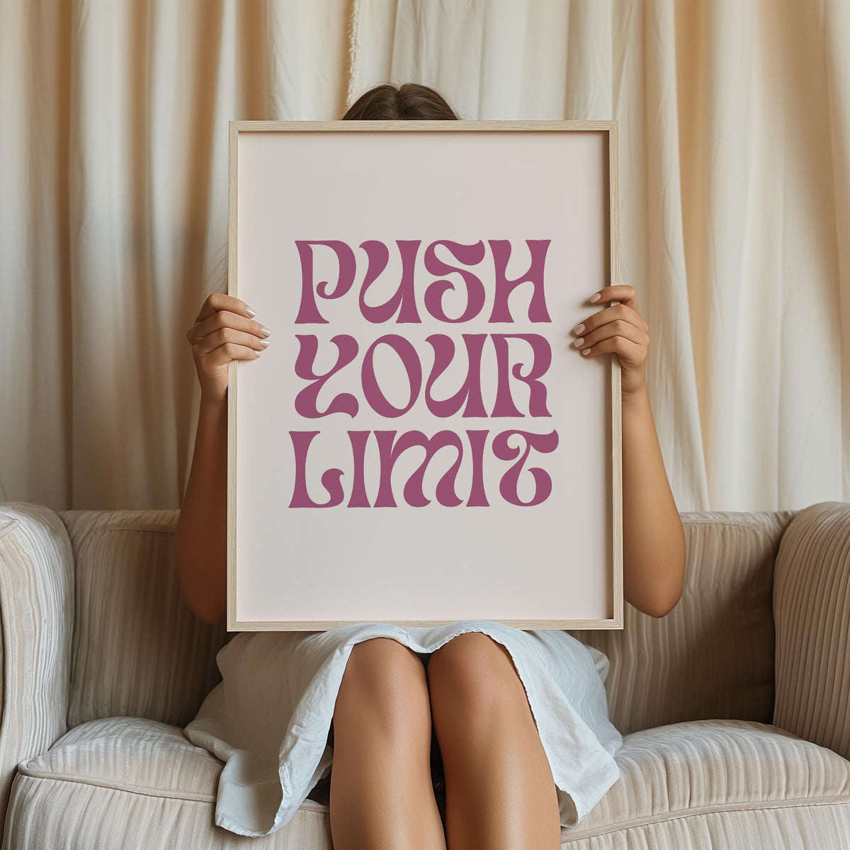 Framed Quote Motivational Poster with pink quote on white held by person on grey sofa