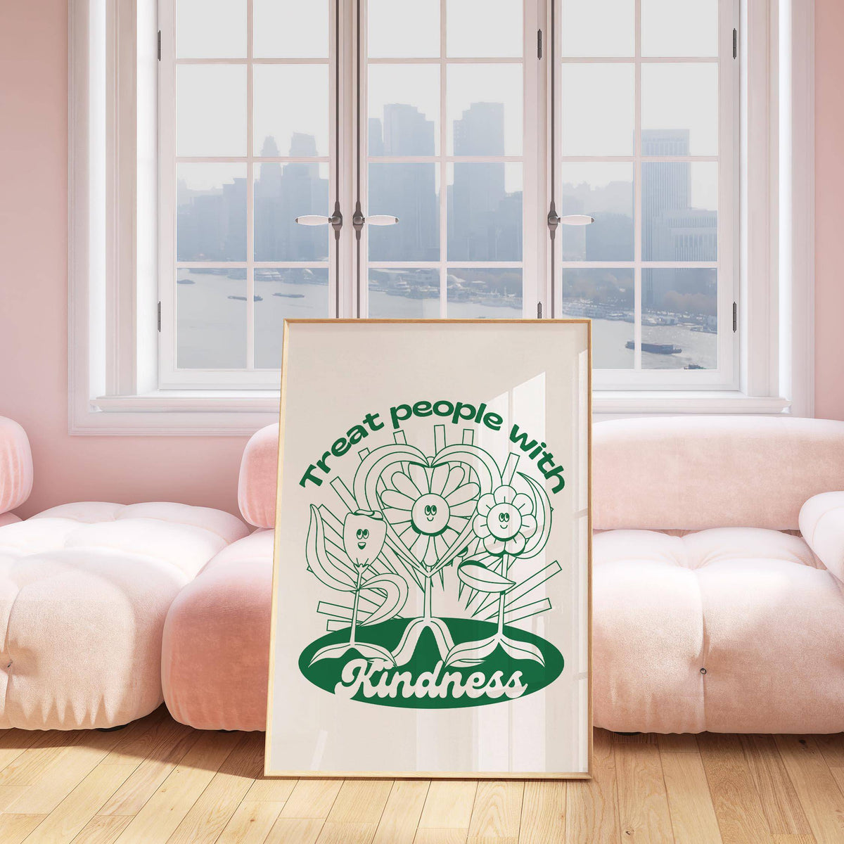 Positive Poster print with smiling flowers in green leaning on a floor against a pink sofa
