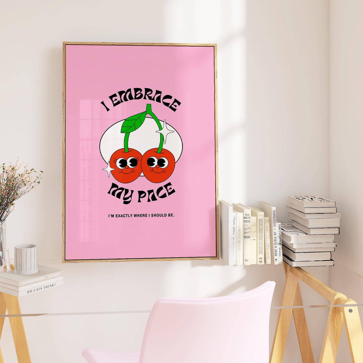 Wall Art for Dorm showing a pair of cherries with text on pink above a desk with books and a pink chair