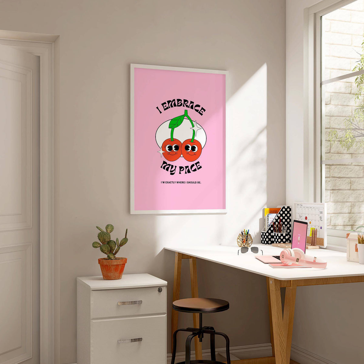 Wall Art for Dorm with a pink background and cherries above a white chest of drawers in a workroom
