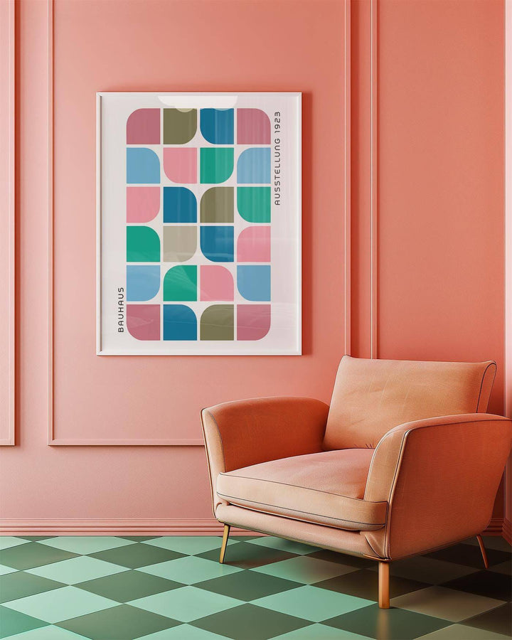 Block Colour wall art with geometric blocks in pink green and blue above a peach armchair in a pink room