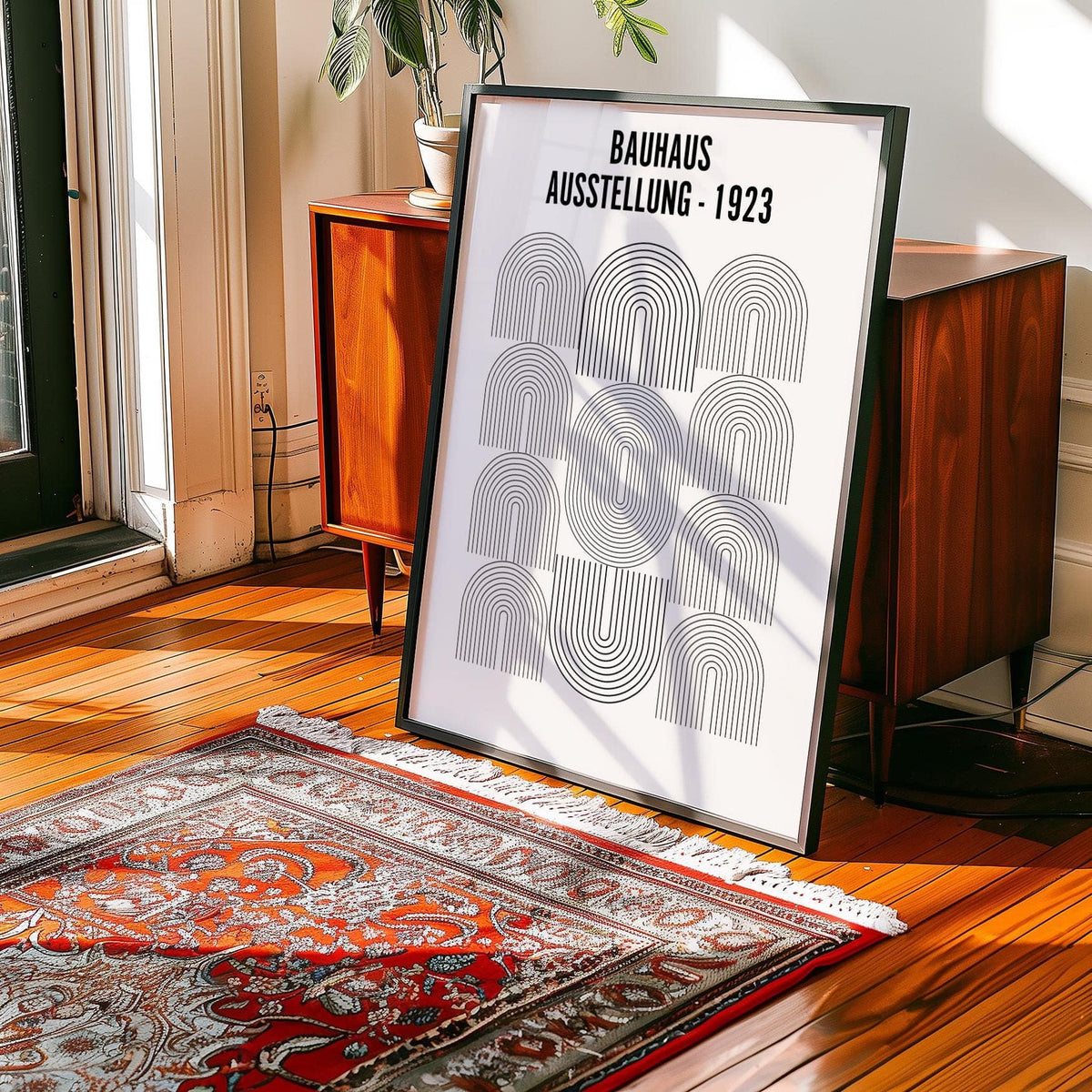 Print leaning on a floor next to a red patterned rug showing black line arches in Bauhaus style