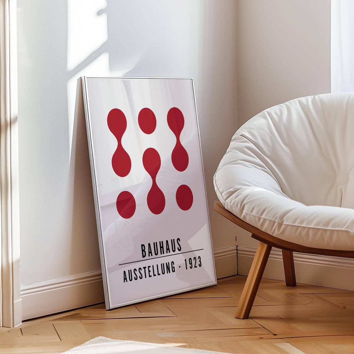 Artwork for Office Walls leaning print with abstract red shapes in minimalist bauhaus style beside a white chair
