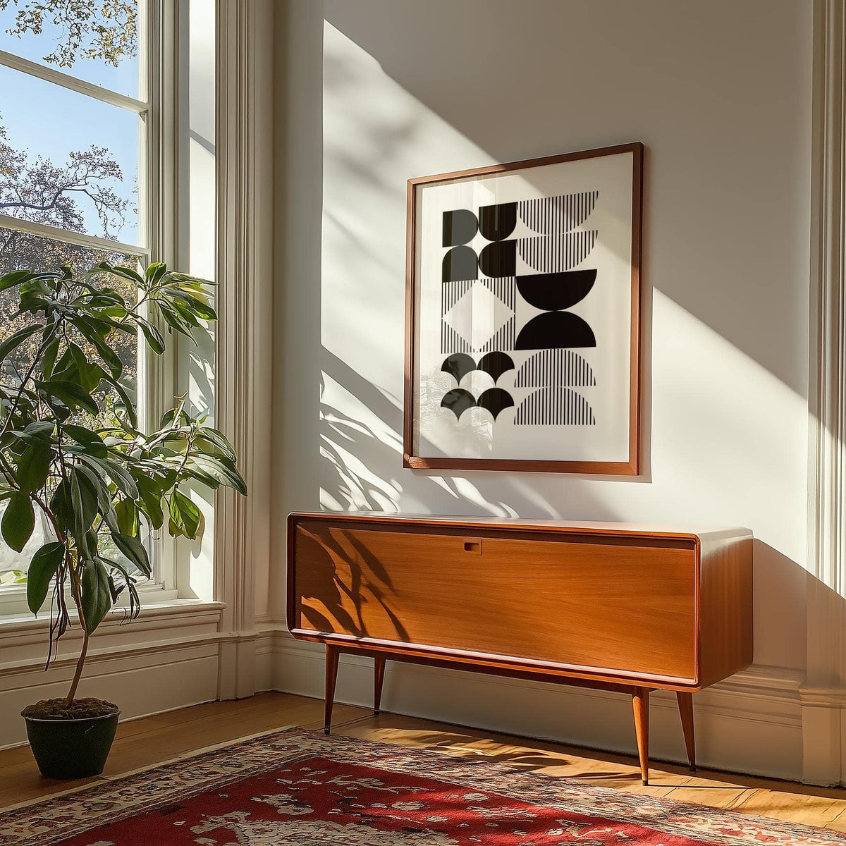 Black and White Geometric Wall Art print on wall with wooden sideboard and green plant by window