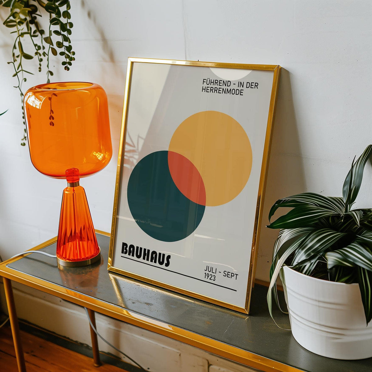Print Geometric framed print with overlapping yellow and green circles beside an orange glass lamp and plant