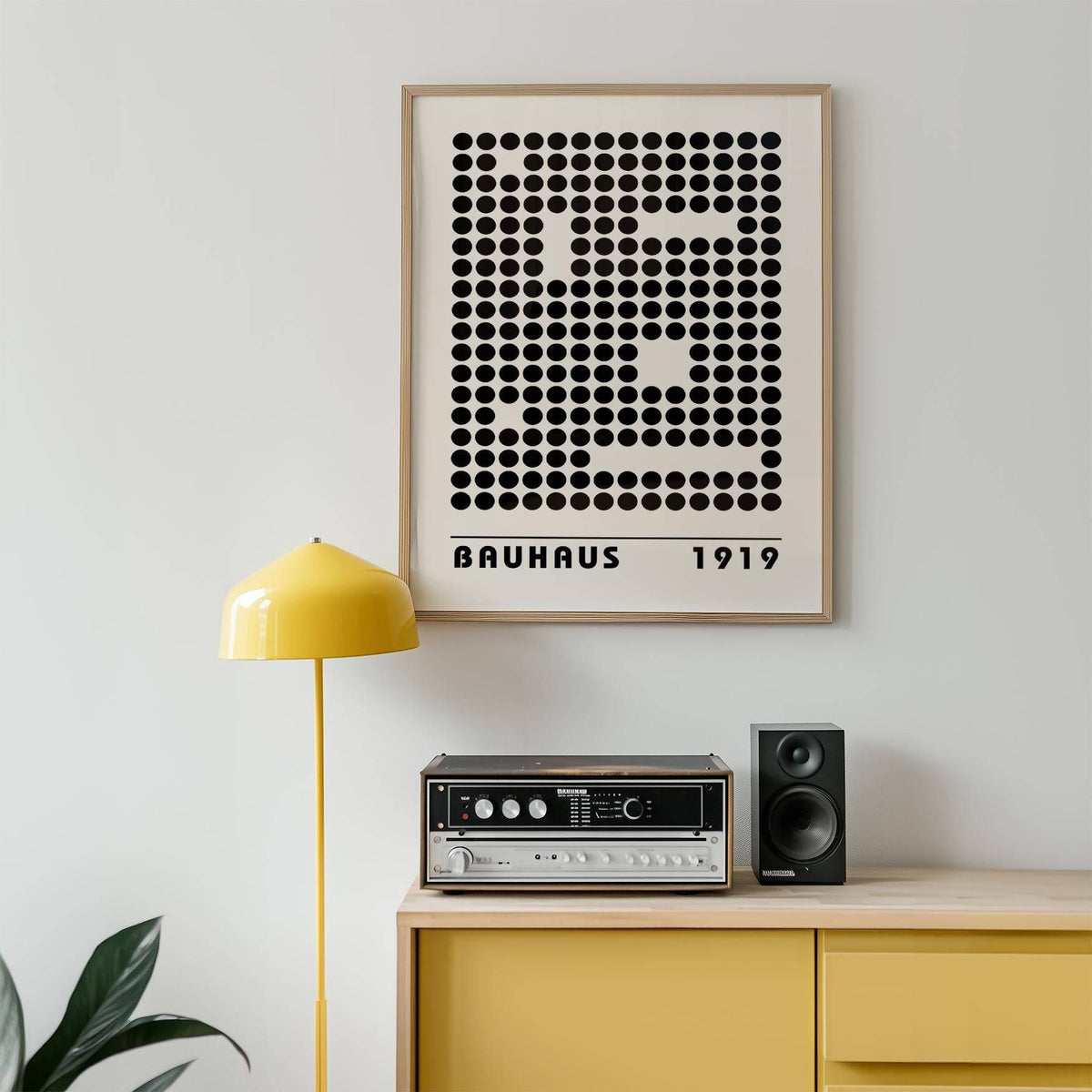 Bauhaus Prints framed print with black dot pattern above yellow sideboard and floor lamp