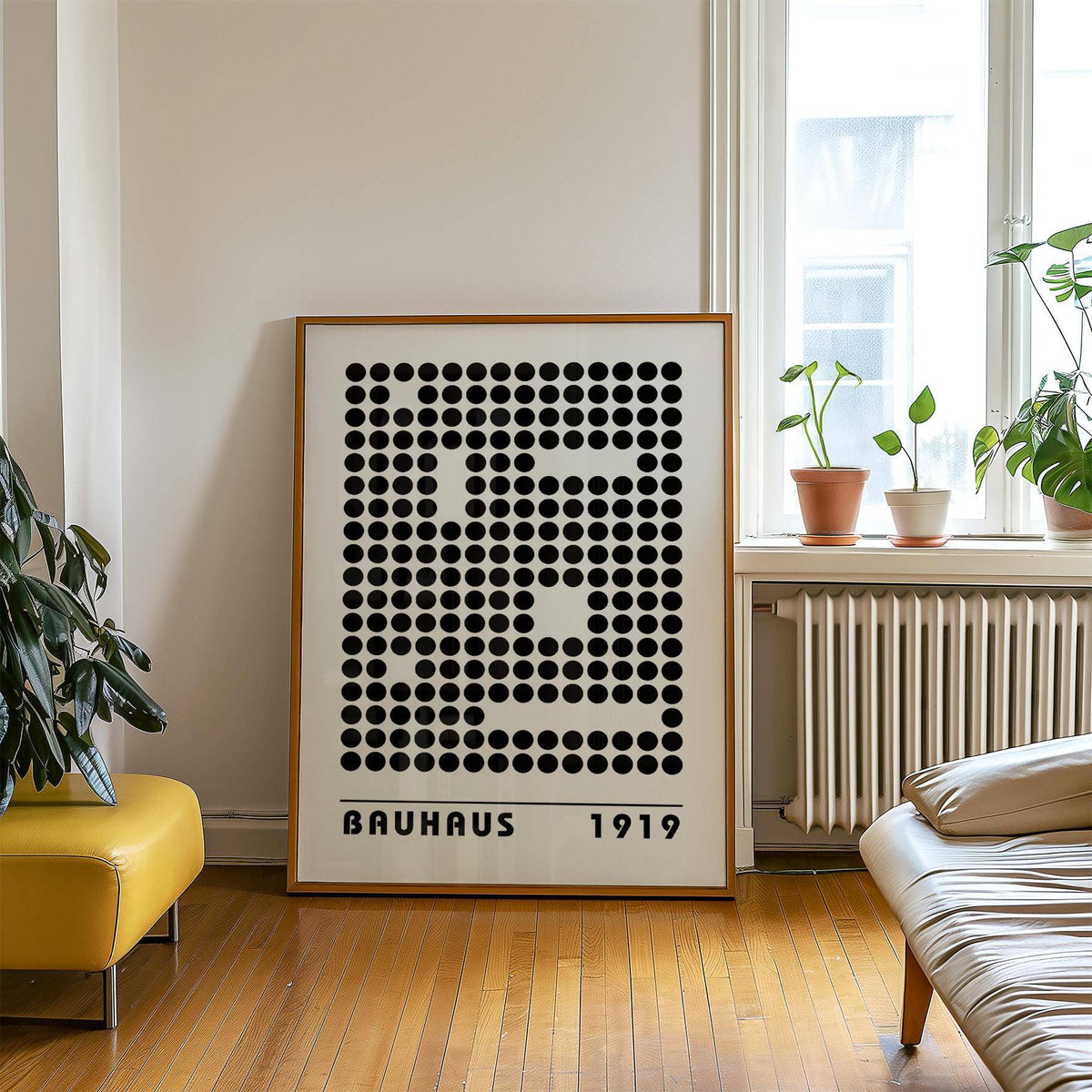 Print leaning on floor of bauhaus prints with black dot pattern near plants on a window ledge