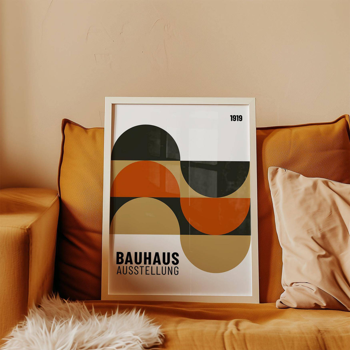 Artwork for the Wall framed print with abstract geometric shapes in orange and tan on a sofa