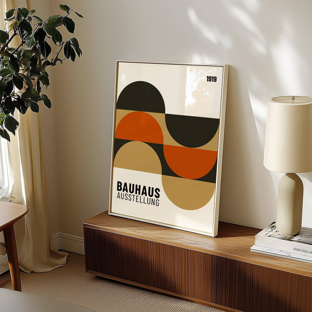 Artwork for the Wall leaning on a wooden cabinet with a lamp and plant nearby