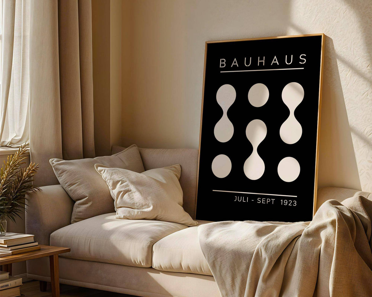 Black and White Geometric Art leaning on a sofa with cushions in a softly lit living room