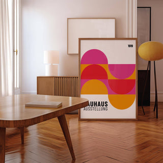 Large Artwork for Walls leaning framed print with colourful geometric semi-circles in a minimalist room with wooden floors