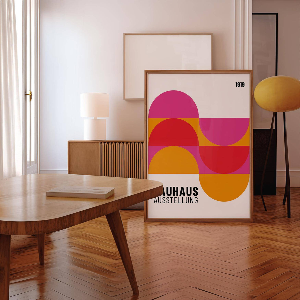 Large Artwork for Walls leaning framed print with colourful geometric semi-circles in a minimalist room with wooden floors